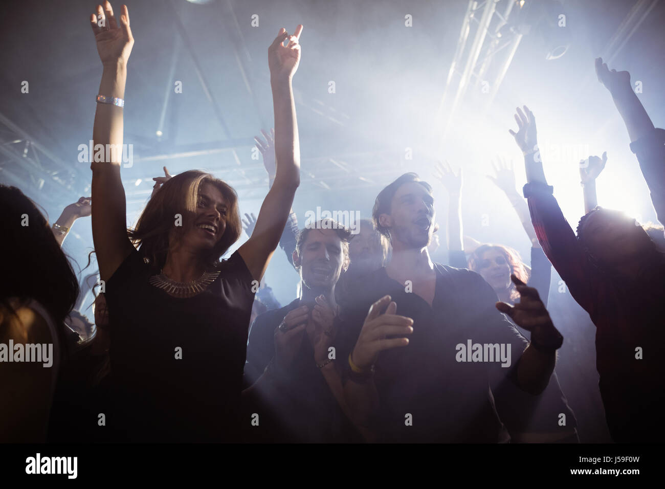 Low angle view of happy people dancing at nightclub Stock Photo