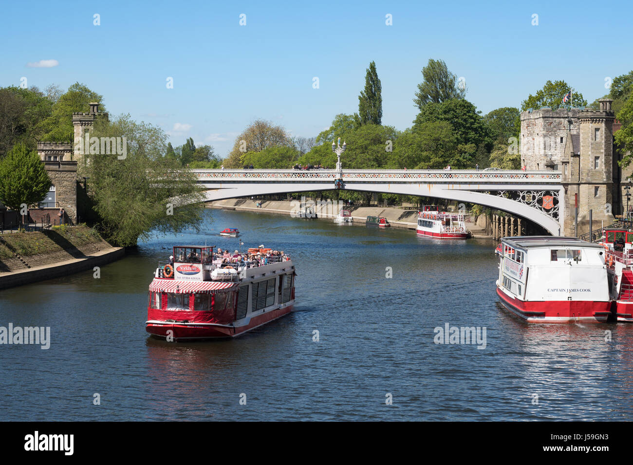 A YorkBoat passes under Lendal bridge with a party of visitors, York, England, UK Stock Photo