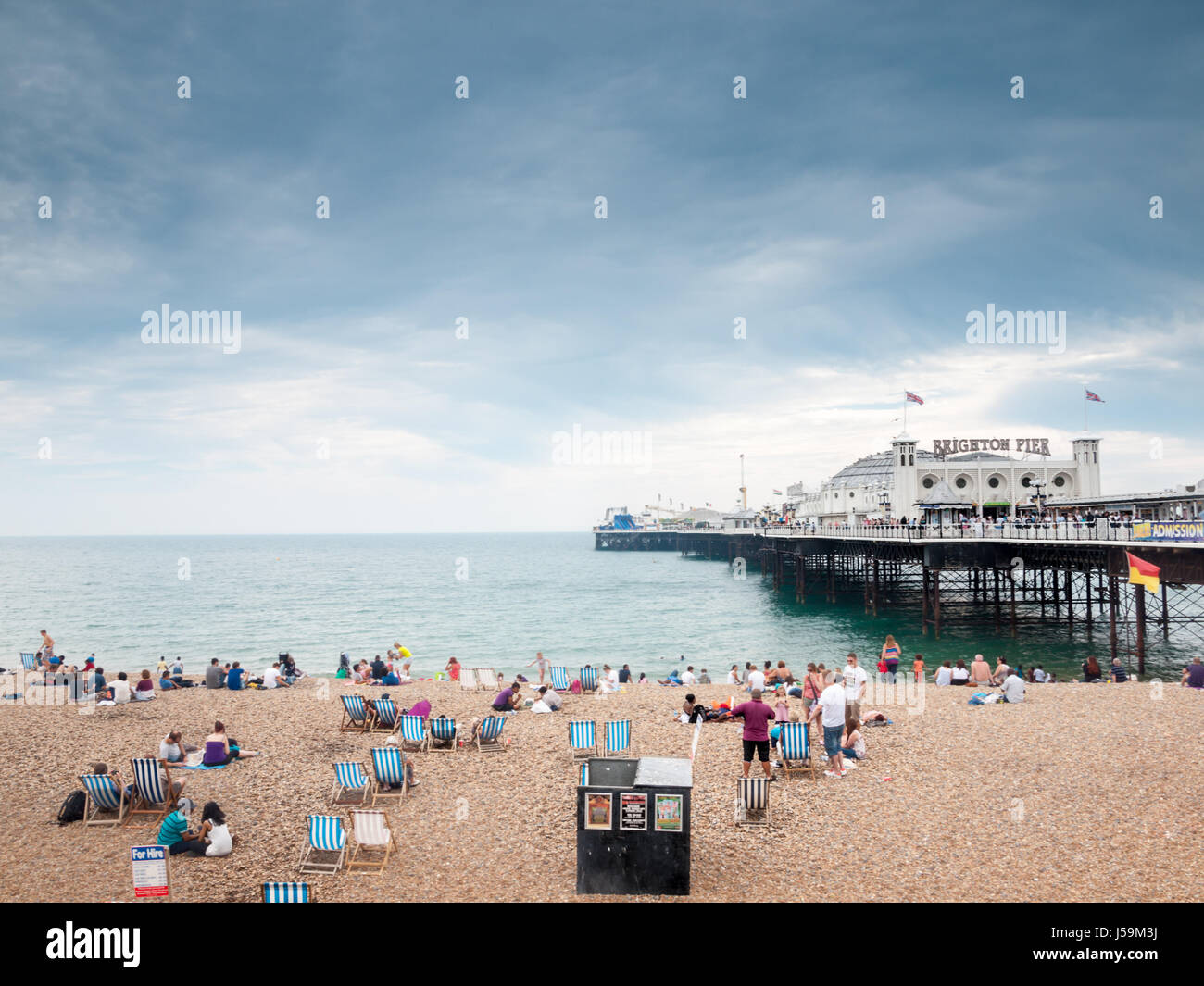 Holidaymakers on Brighton Beach and Pier Stock Photo
