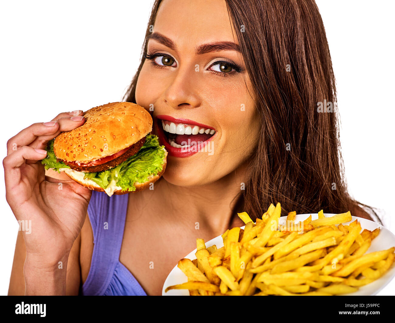 Woman eating french fries and hamburger on table Stock Photo Alamy