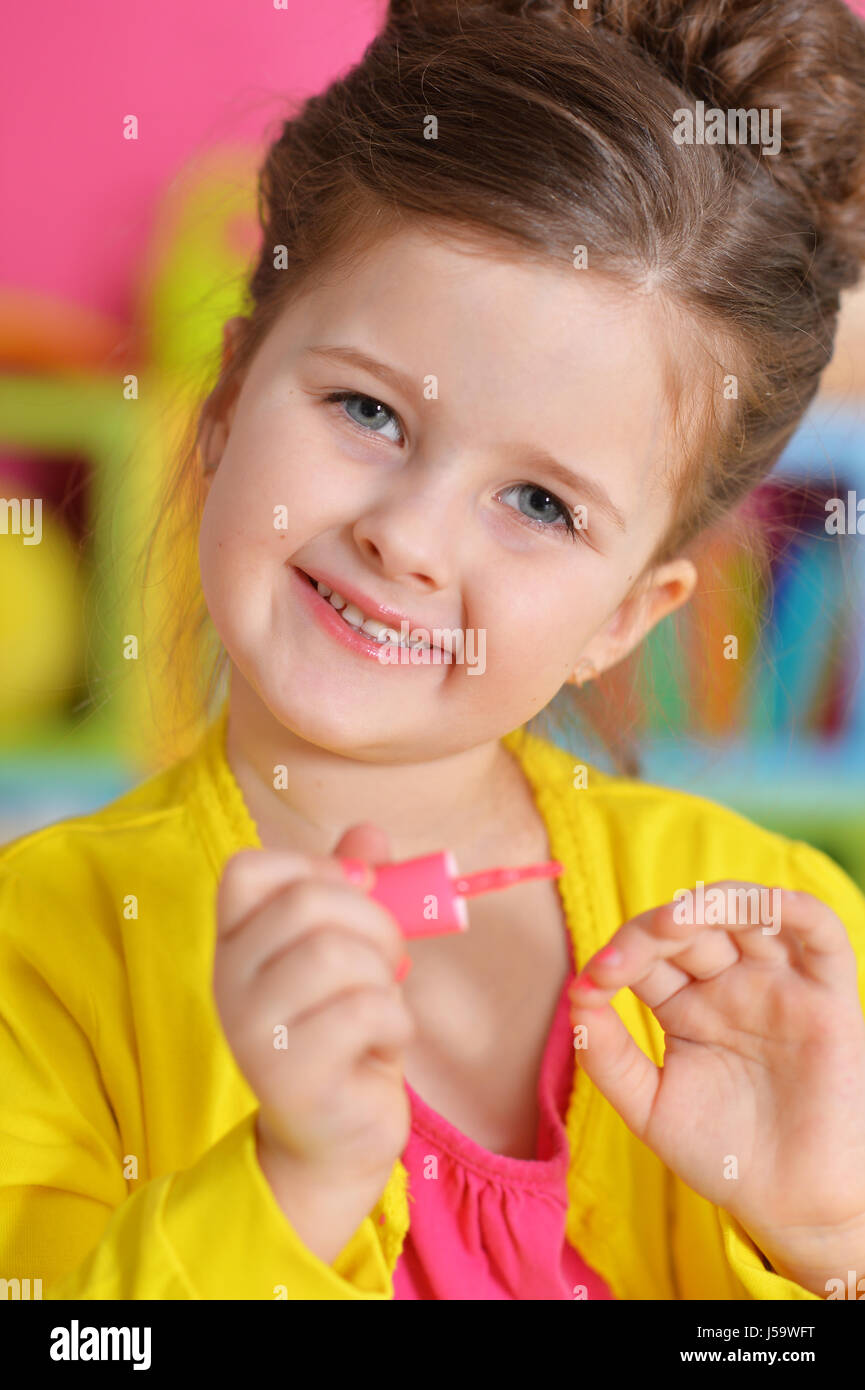 Beautiful girl paints her nails Stock Photo Alamy