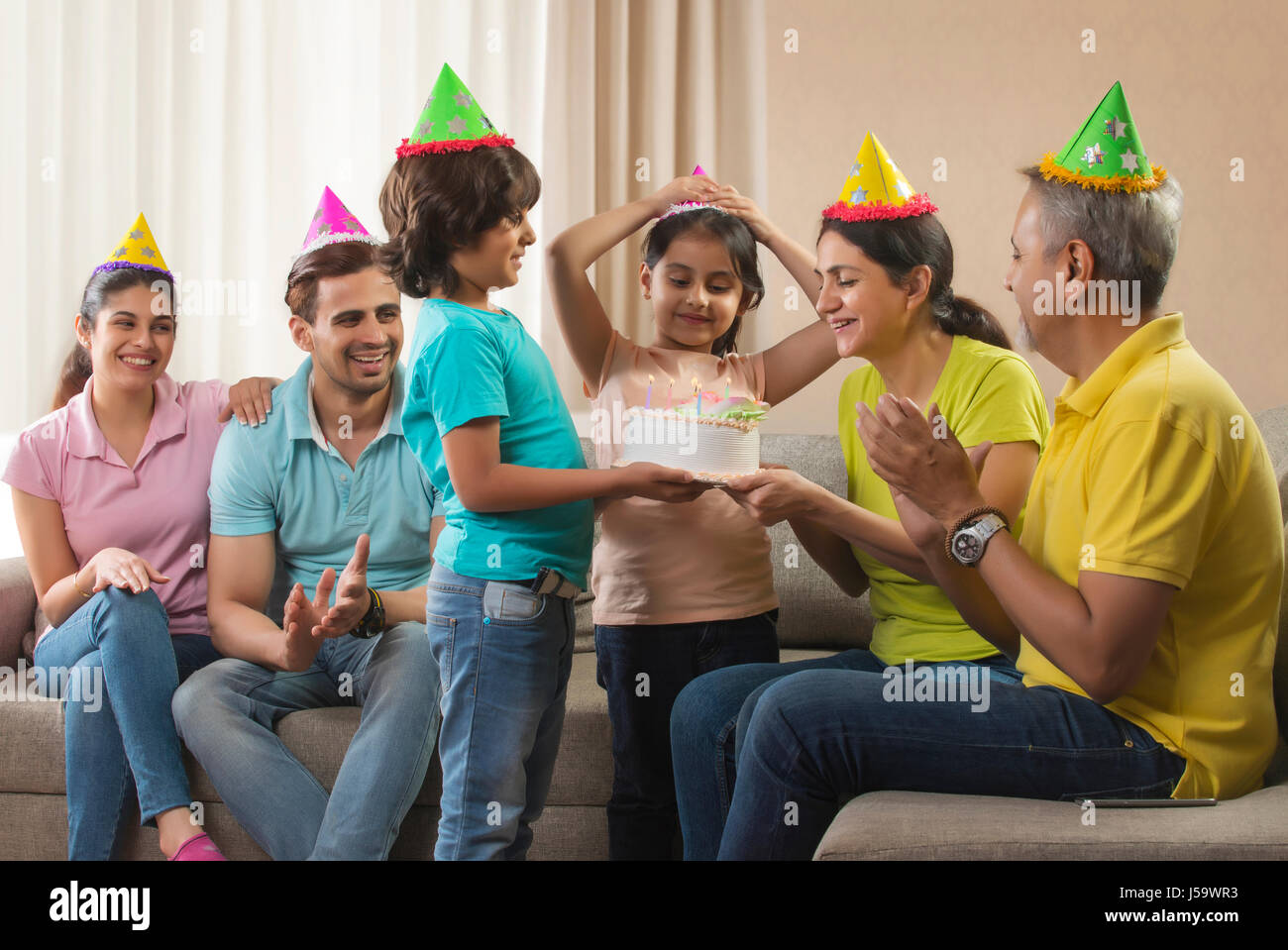 Family giving birthday party to grandmother Stock Photo