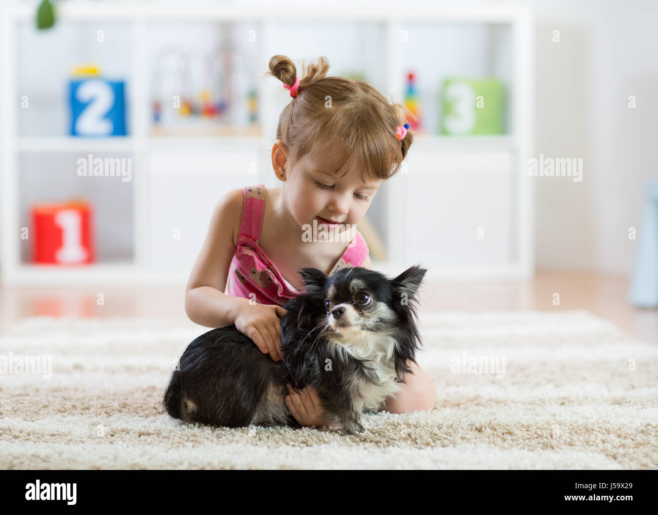 Lovely little girl and her pet dog Stock Photo
