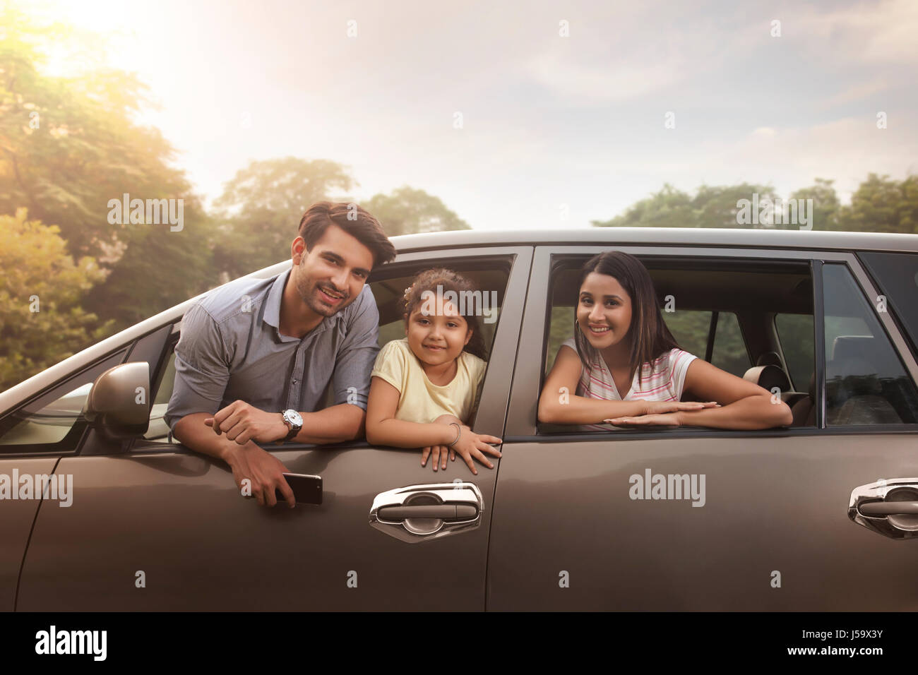 Family looking out car window Stock Photo