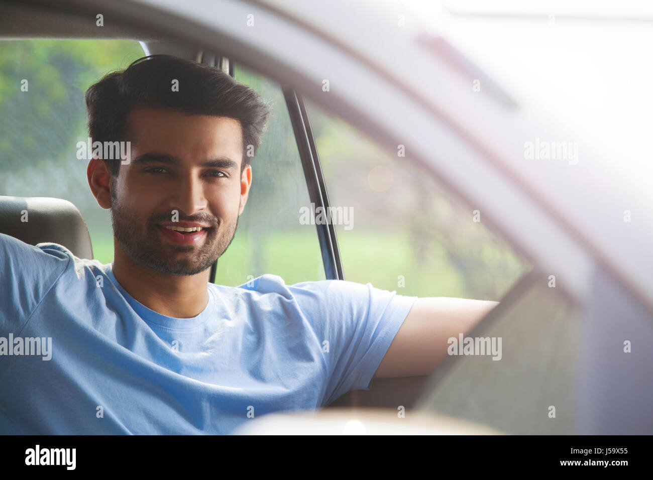 Portrait of young man sitting in car Stock Photo