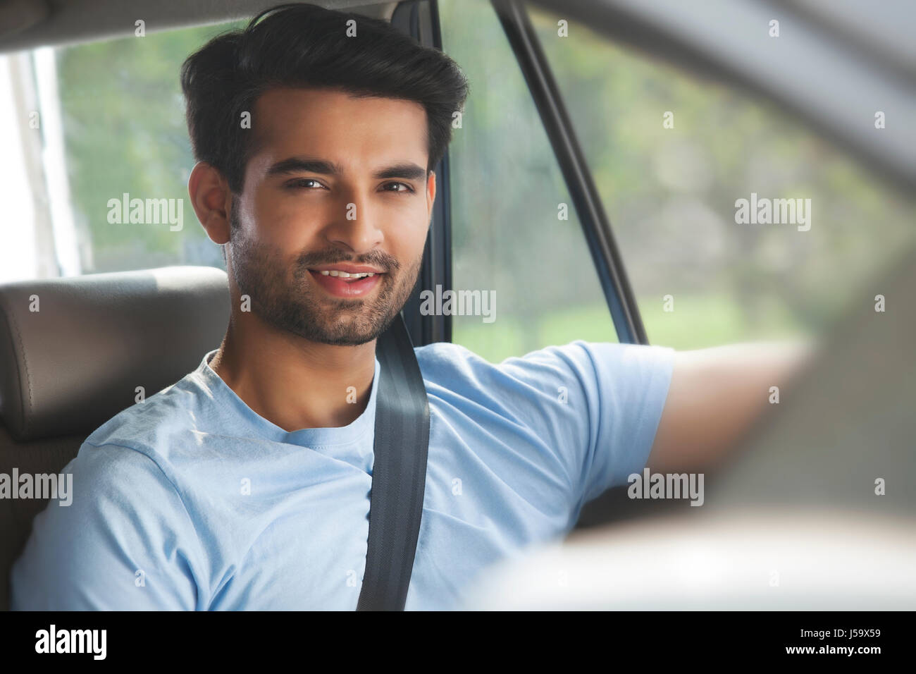 Portrait of young man sitting in car Stock Photo