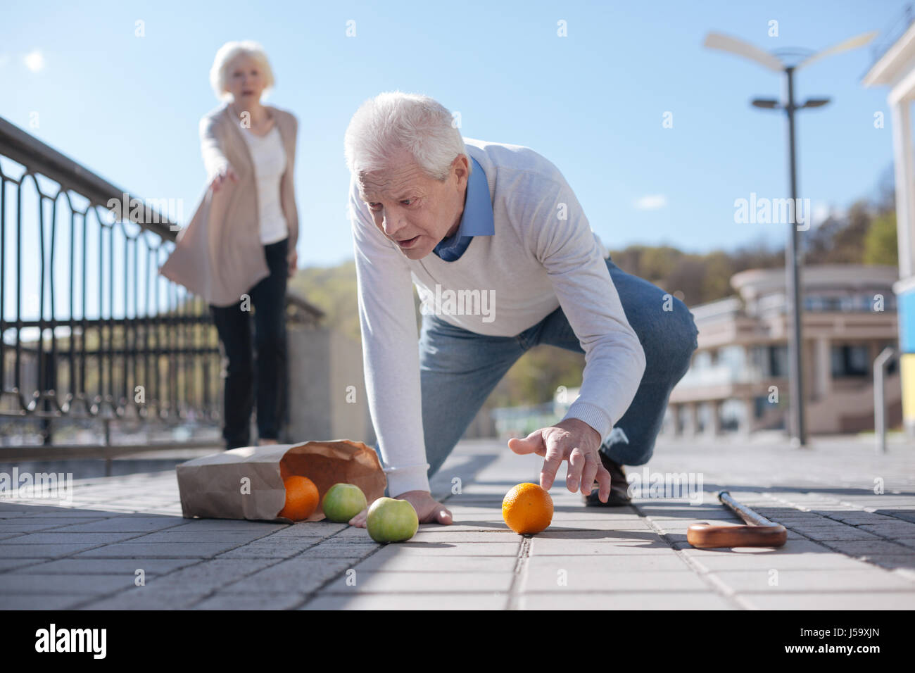 old-man-falling-down-in-the-street-J59XJN.jpg