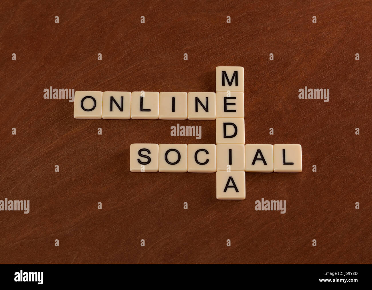 Crossword puzzle with words Online, Social, Media. Digital marketing  concept. Ivory tiles with capital letters on mahogany board Stock Photo -  Alamy