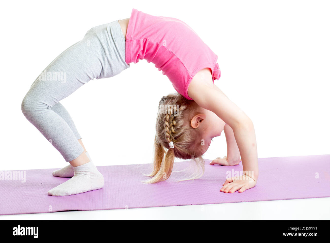 kid girl doing gymnastics on fitness mat Stock Photo