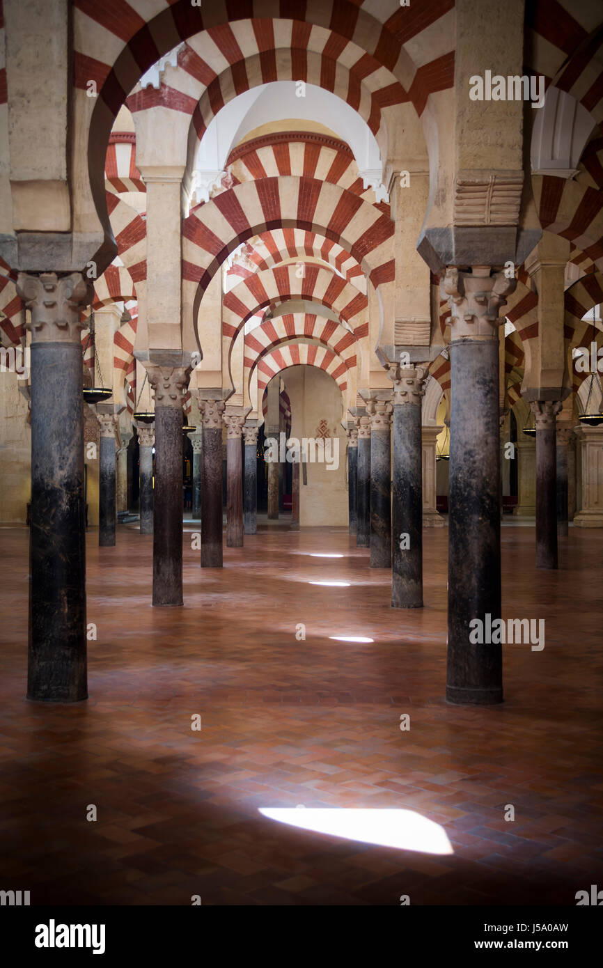 Red And White Stone Arches In Mosque Cathedral Of Cordoba In