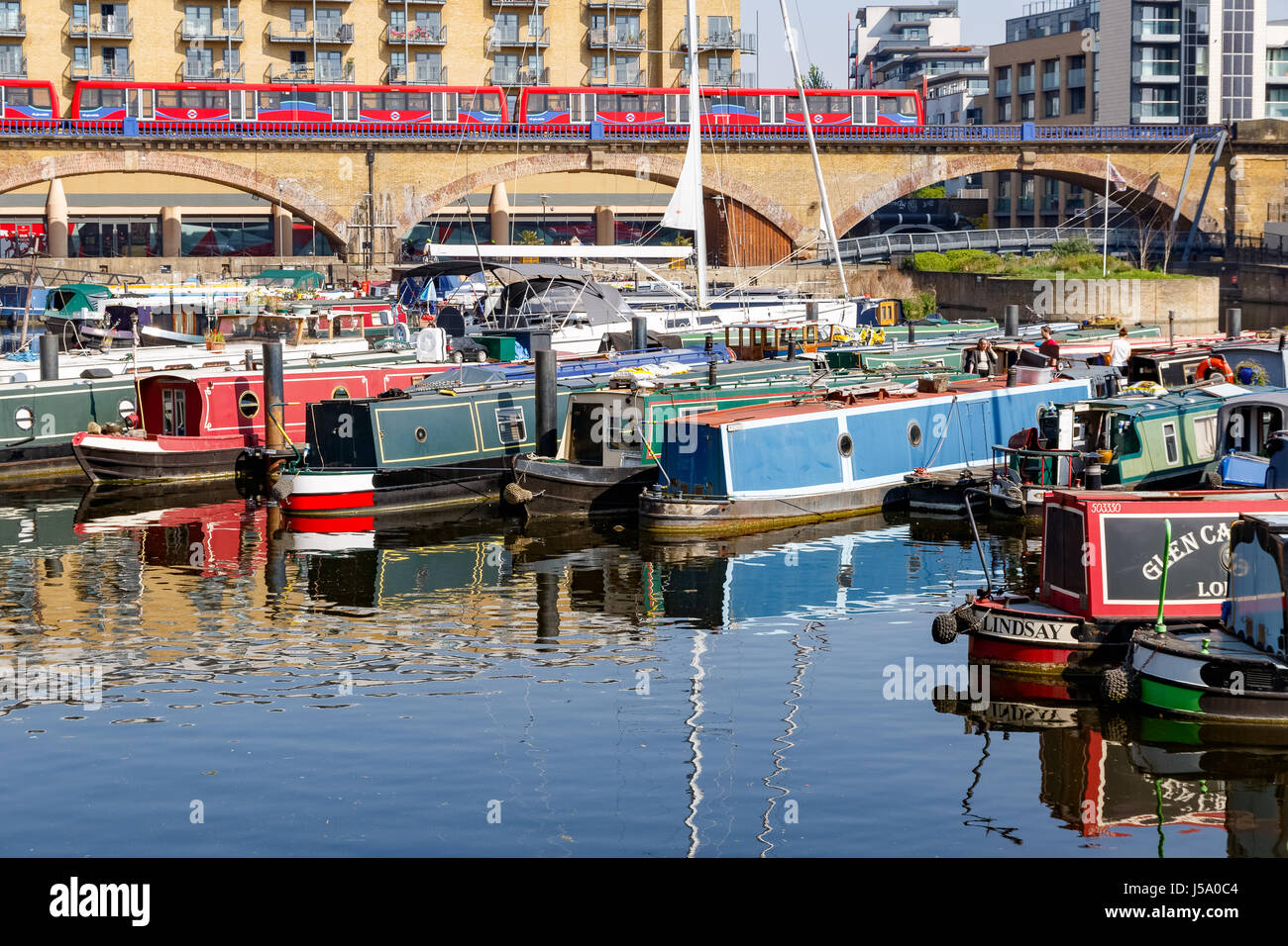 London, UK - April 8, 2017 - Boats and yacht moored at Limehouse Basin Marina with Docklands Light Railway passing by in the background Stock Photo