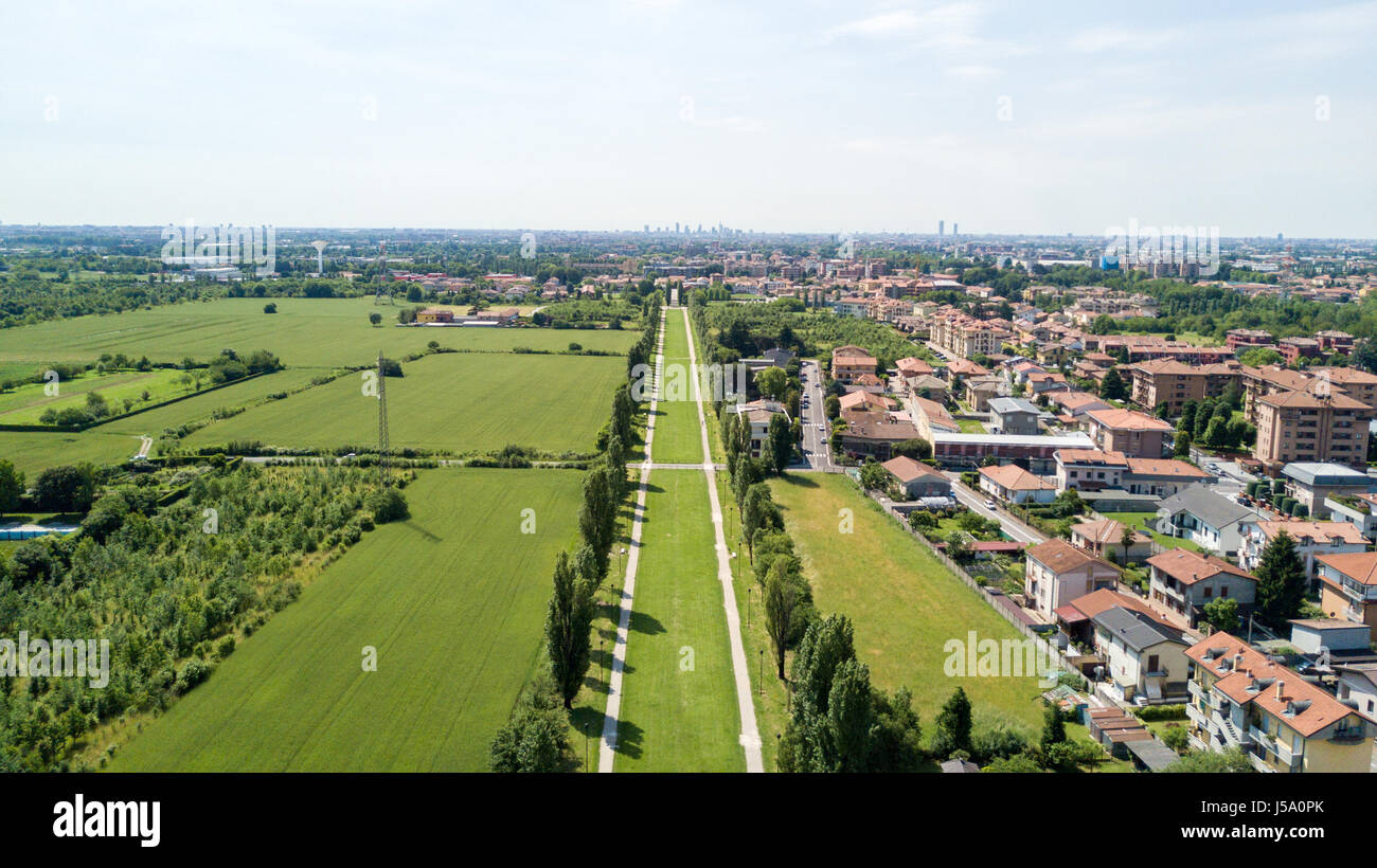 New Skyline of Milan seen from the Milanese hinterland, aerial view, tree lined avenue. Pedestrian cycle path. Varedo, Monza Brianza, Lombardy. Italy Stock Photo