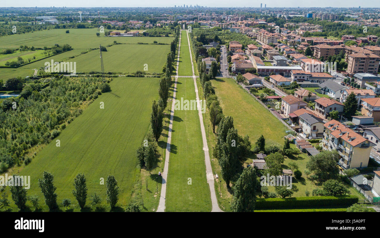 New Skyline of Milan seen from the Milanese hinterland, aerial view, tree lined avenue. Pedestrian cycle path. Varedo, Monza Brianza, Lombardy. Italy Stock Photo