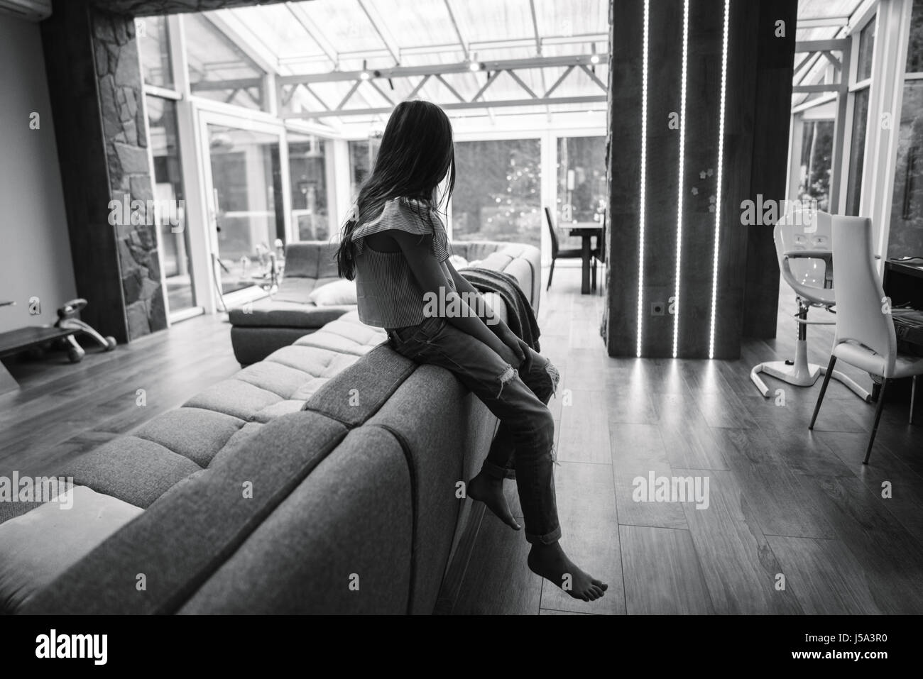 Positive smiling teenage girl on a couch Stock Photo - Alamy