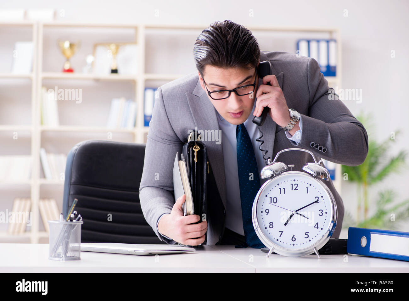 Businessman rushing in the office Stock Photo - Alamy