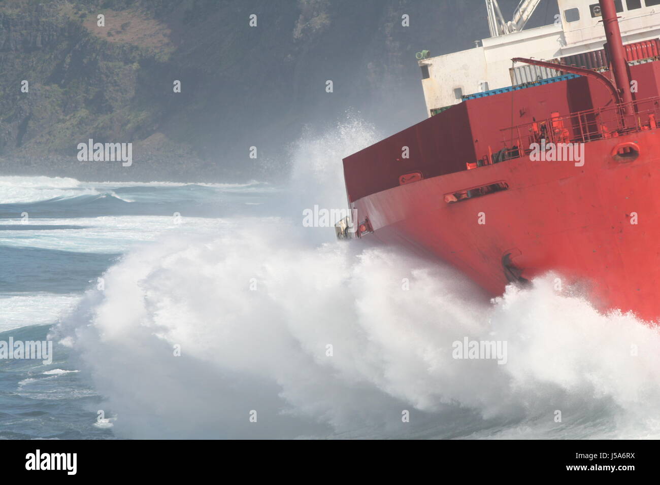 container ship navigation waves coast bay aground surf catastrophe azores Stock Photo