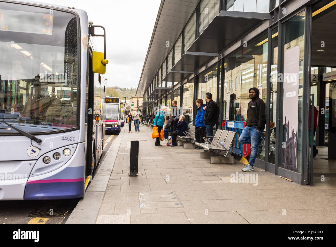 Commuters waiting at bus stop hires stock photography and images Alamy