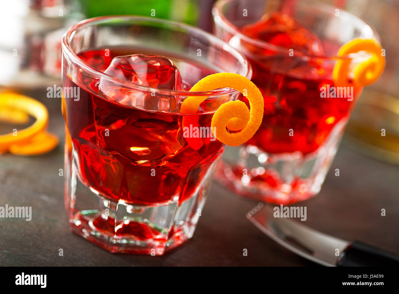 Delicious negroni cocktails with campari, gin, vermouth, and a citrus orange twist Stock Photo