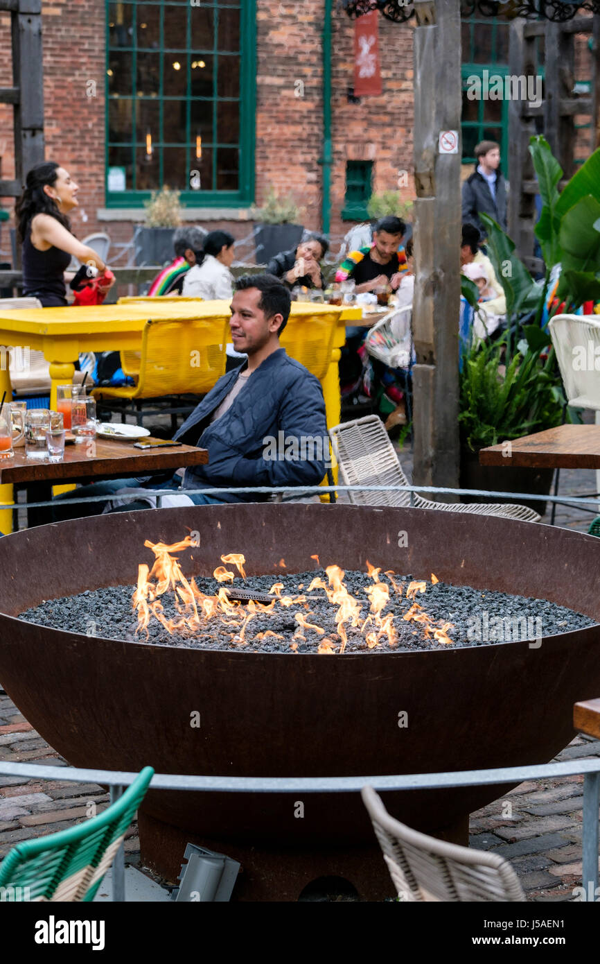 El Catrin Destileria Mexican restaurant outside patio, firepit, customers eating out, tables and chairs, The Distillery Historic District, Toronto, On Stock Photo