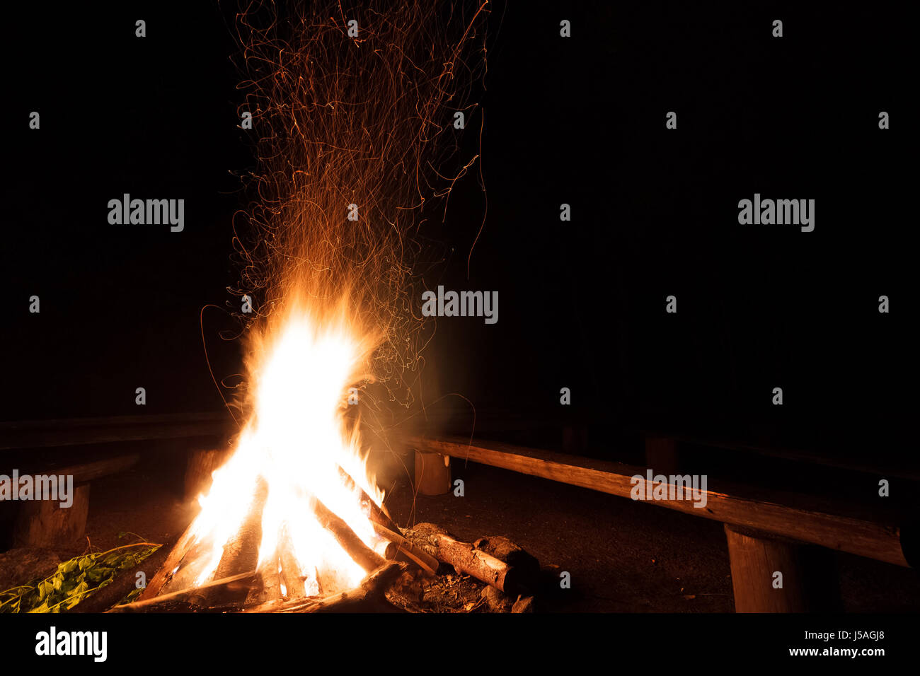 Campfire with flying sparks in the night Stock Photo - Alamy