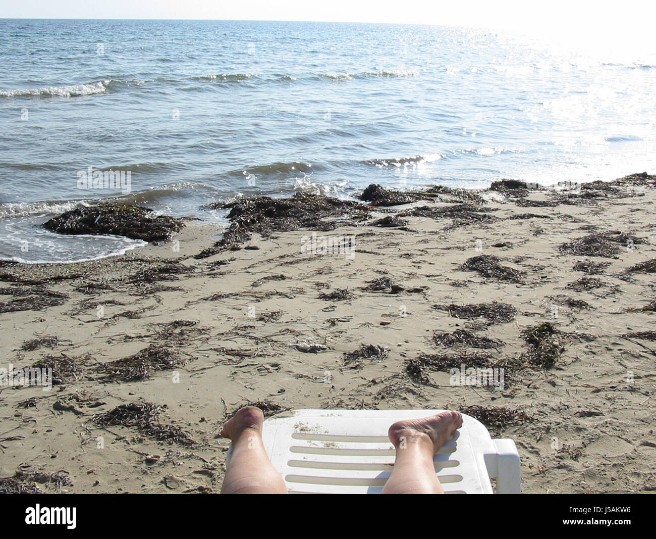 barefoot on a greek beach Stock Photo - Alamy