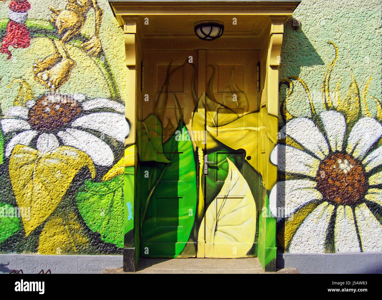 house building art flower plant entrance door coloured berlin painting daub Stock Photo