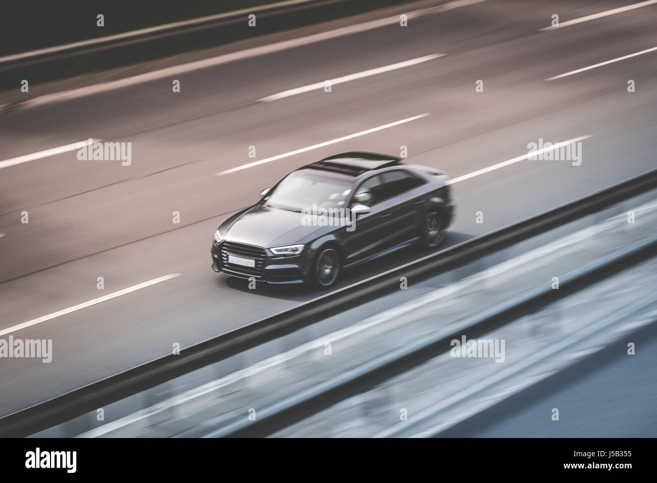 black car driving fast on highway Stock Photo Alamy