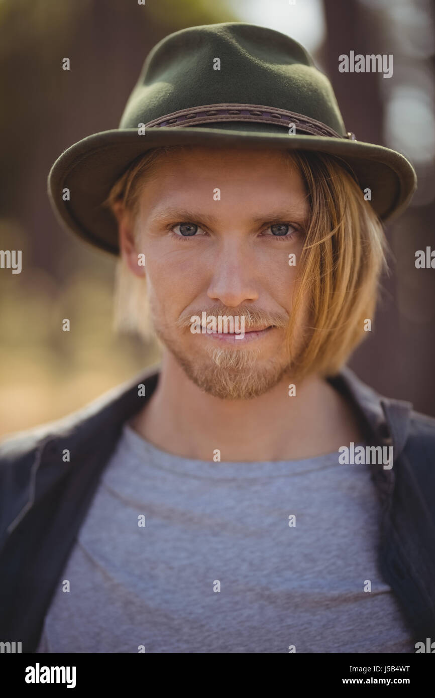 Portrait of young man standing in forest Stock Photo - Alamy