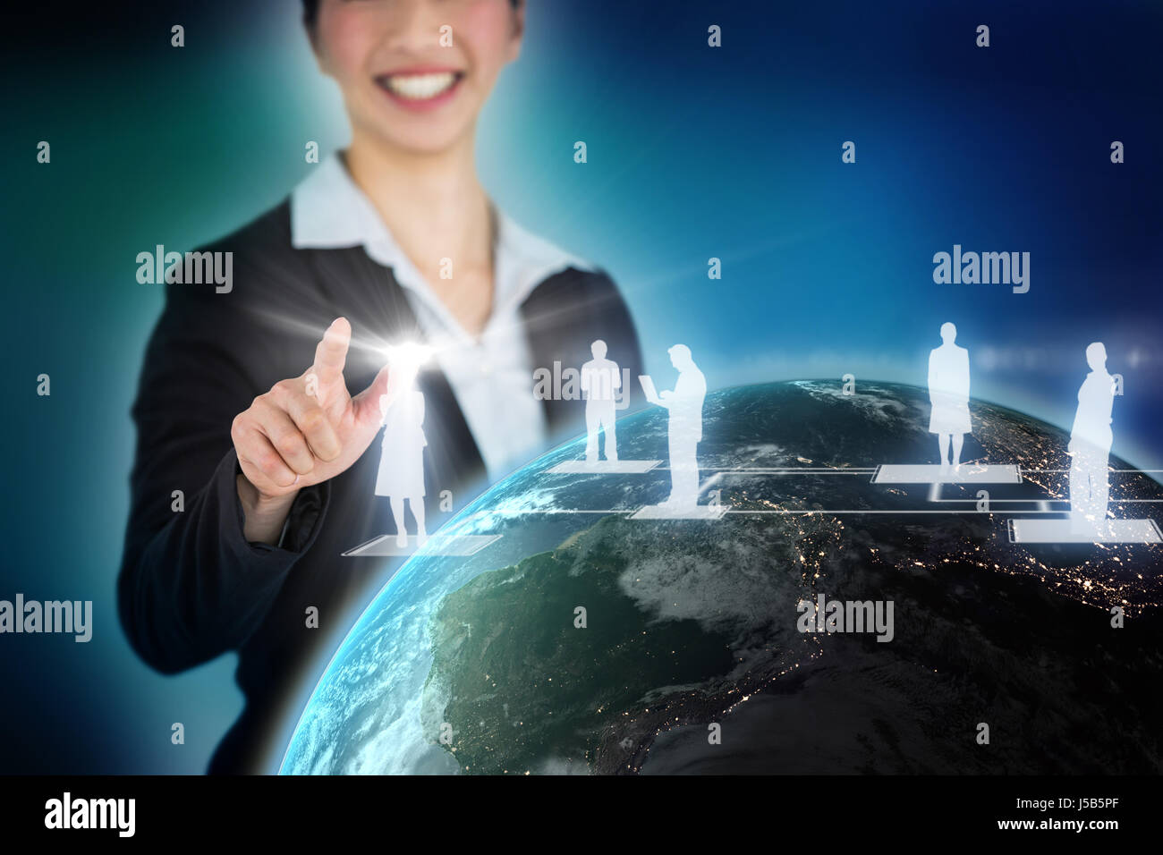 Happy businesswoman touching digital screen against blue background with vignette Stock Photo