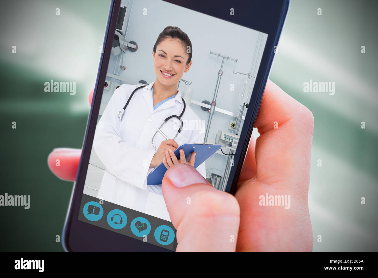 Woman using her mobile phone against sterile bedroom Stock Photo