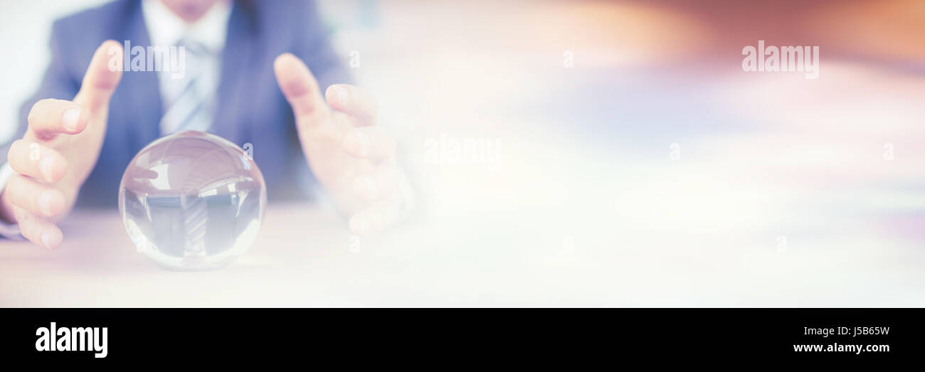 Businessman forecasting a crystal ball in the office Stock Photo - Alamy