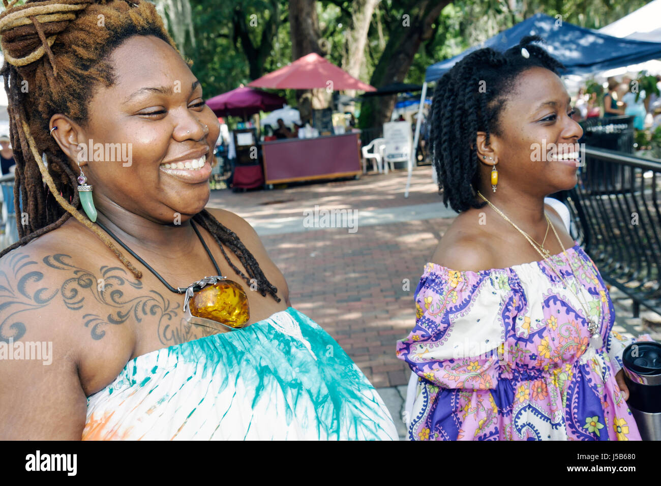 Orlando Florida,Lake Eola Park,farmers market,Black woman female women,amber necklace,hairdo,tattoo,luxury,well dressed,exotic,smile,smiling,FL0808240 Stock Photo