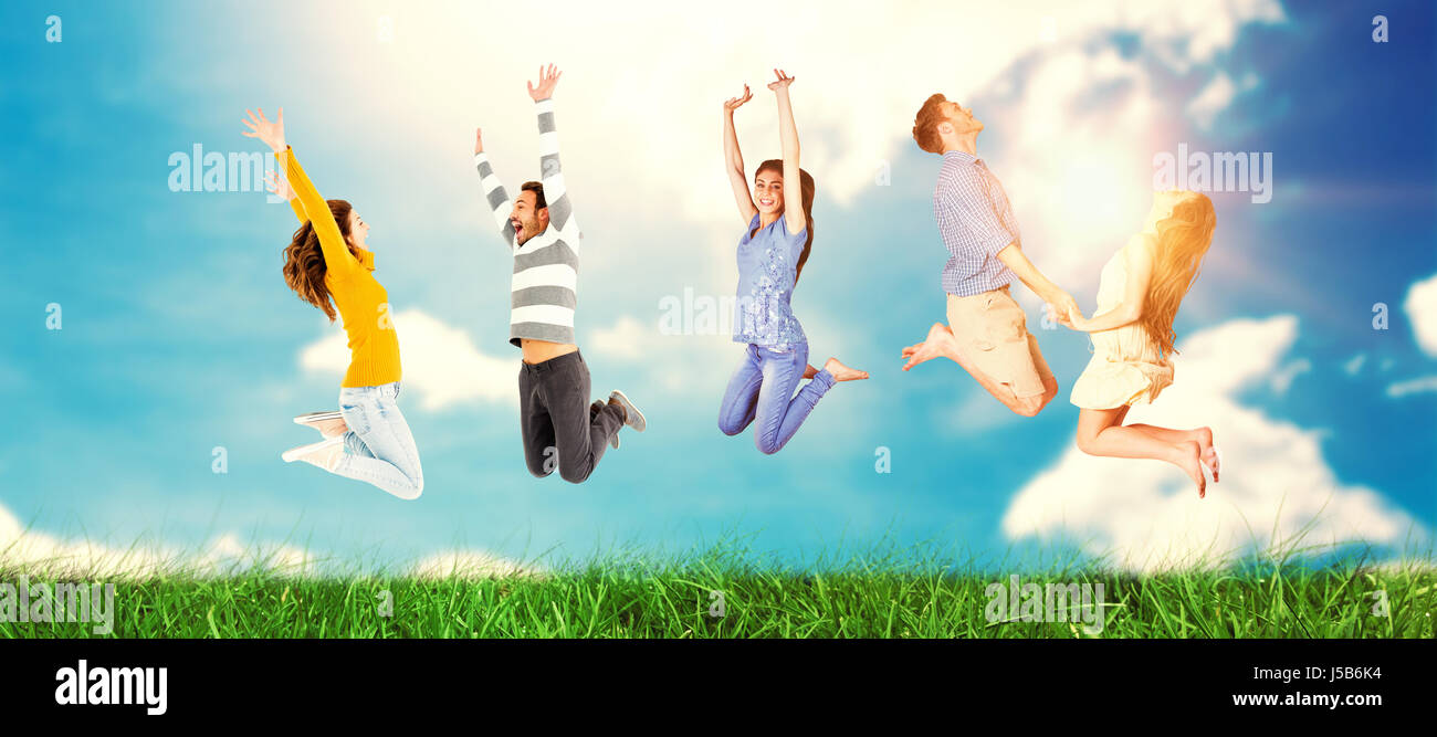 Happy friends jumping against blue sky Stock Photo - Alamy