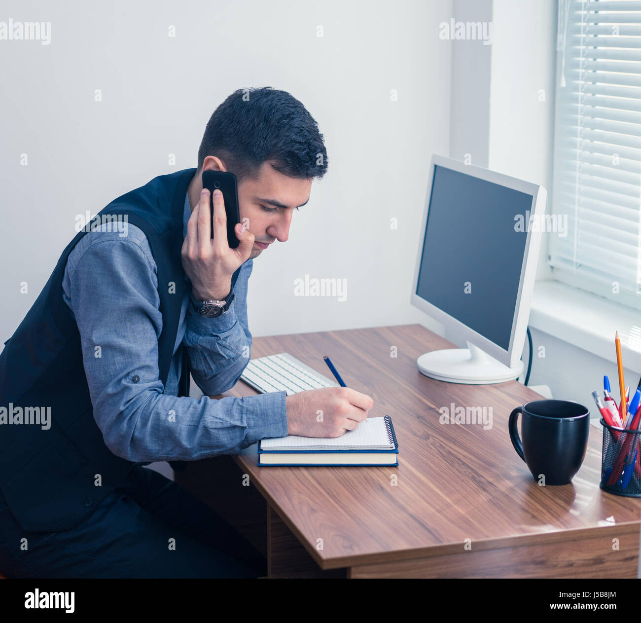 office worker takes an order by phone Stock Photo