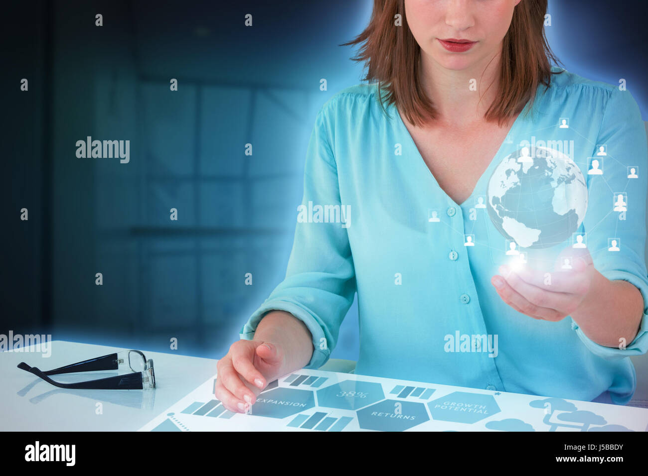 Businesswoman sitting at desk and using digital screen against composite image of graph Stock Photo