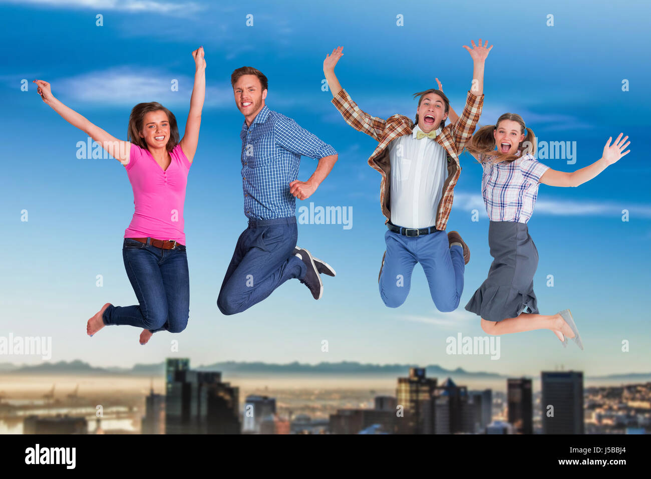 Full length of friends jumping against city Stock Photo - Alamy