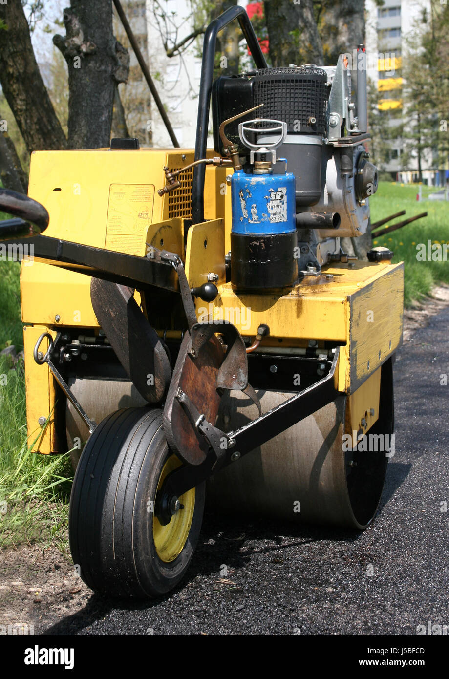 repair holes punch tar building machine mend patch repairs road hole road Stock Photo
