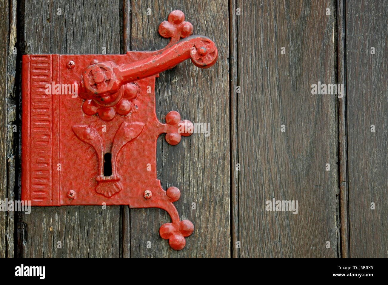 iron ailing low carbon steel weatherworn keyhole wooden planks ornaments red Stock Photo