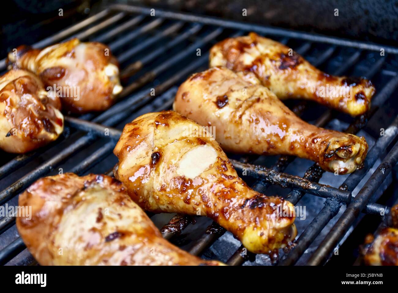 Chicken drumsticks on barbecue grill Stock Photo Alamy