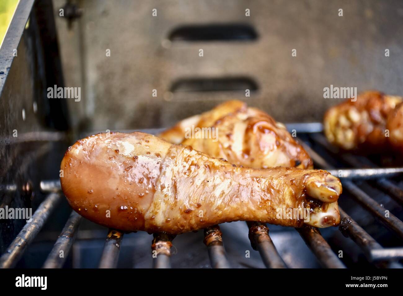 Chicken drumsticks on barbecue grill Stock Photo Alamy