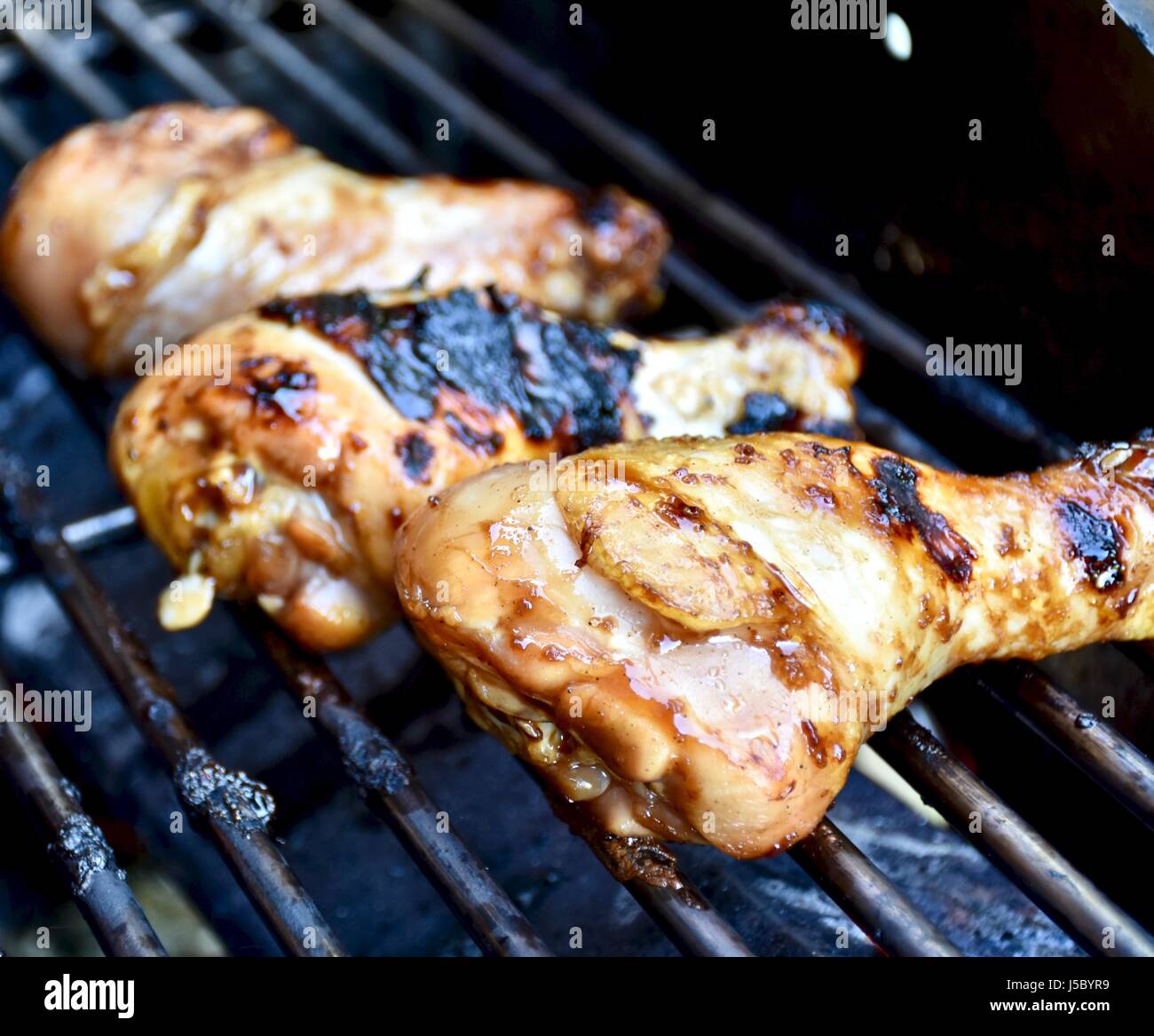 Chicken drumsticks on barbecue grill Stock Photo Alamy