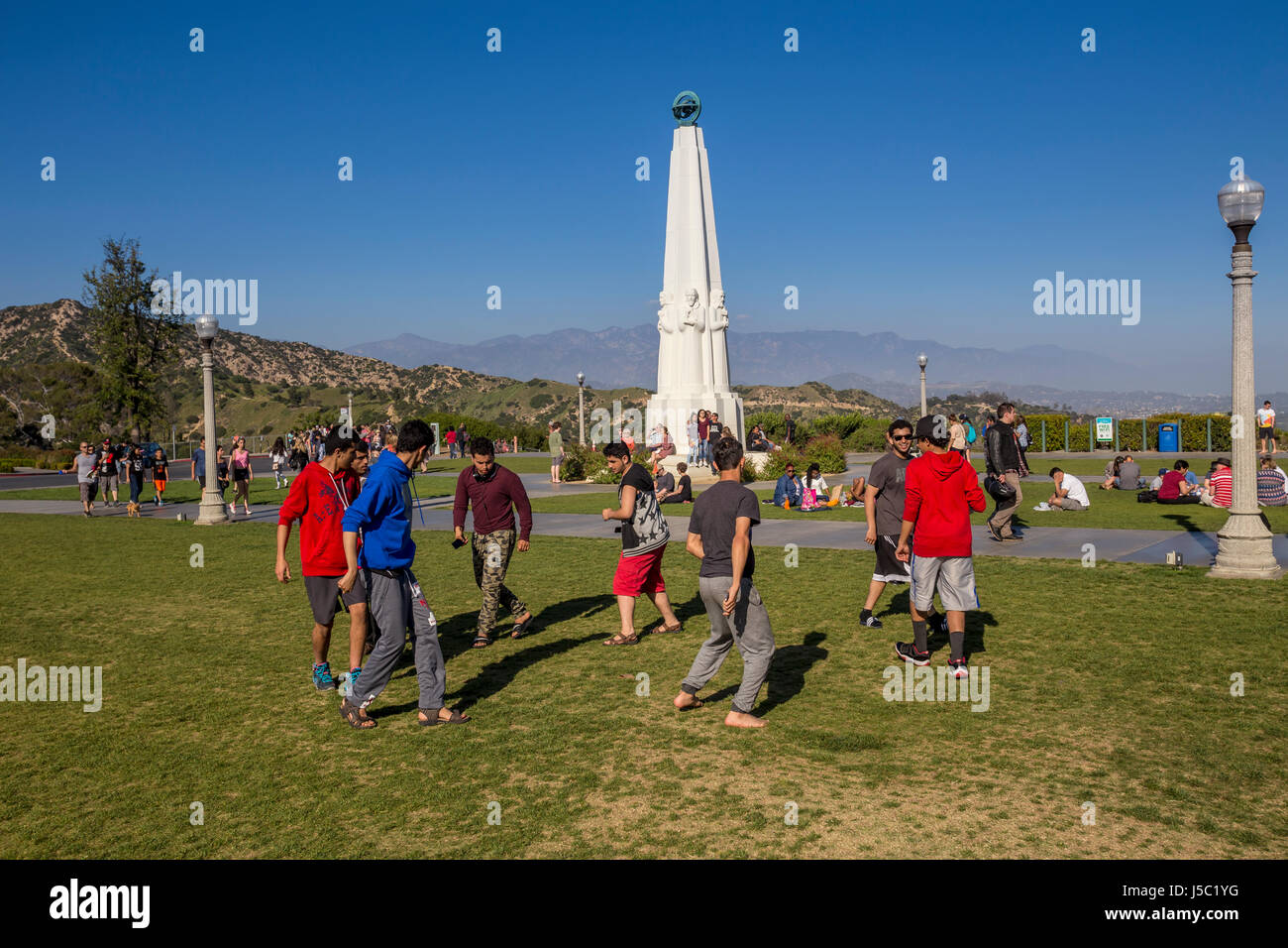 people, tourists, dancing, ethnic dance, lawn, observatory grounds, Astronomers Monument, Griffith Observatory, Griffith Park, Los Angeles, California Stock Photo