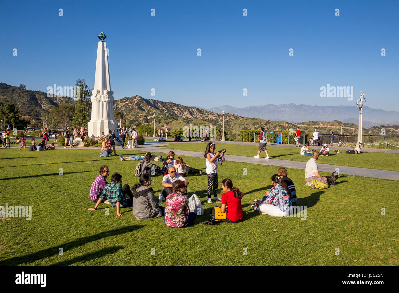 people, tourists, lawn, observatory grounds, Astronomers Monument, Griffith Observatory, Griffith Park, Los Angeles, California Stock Photo