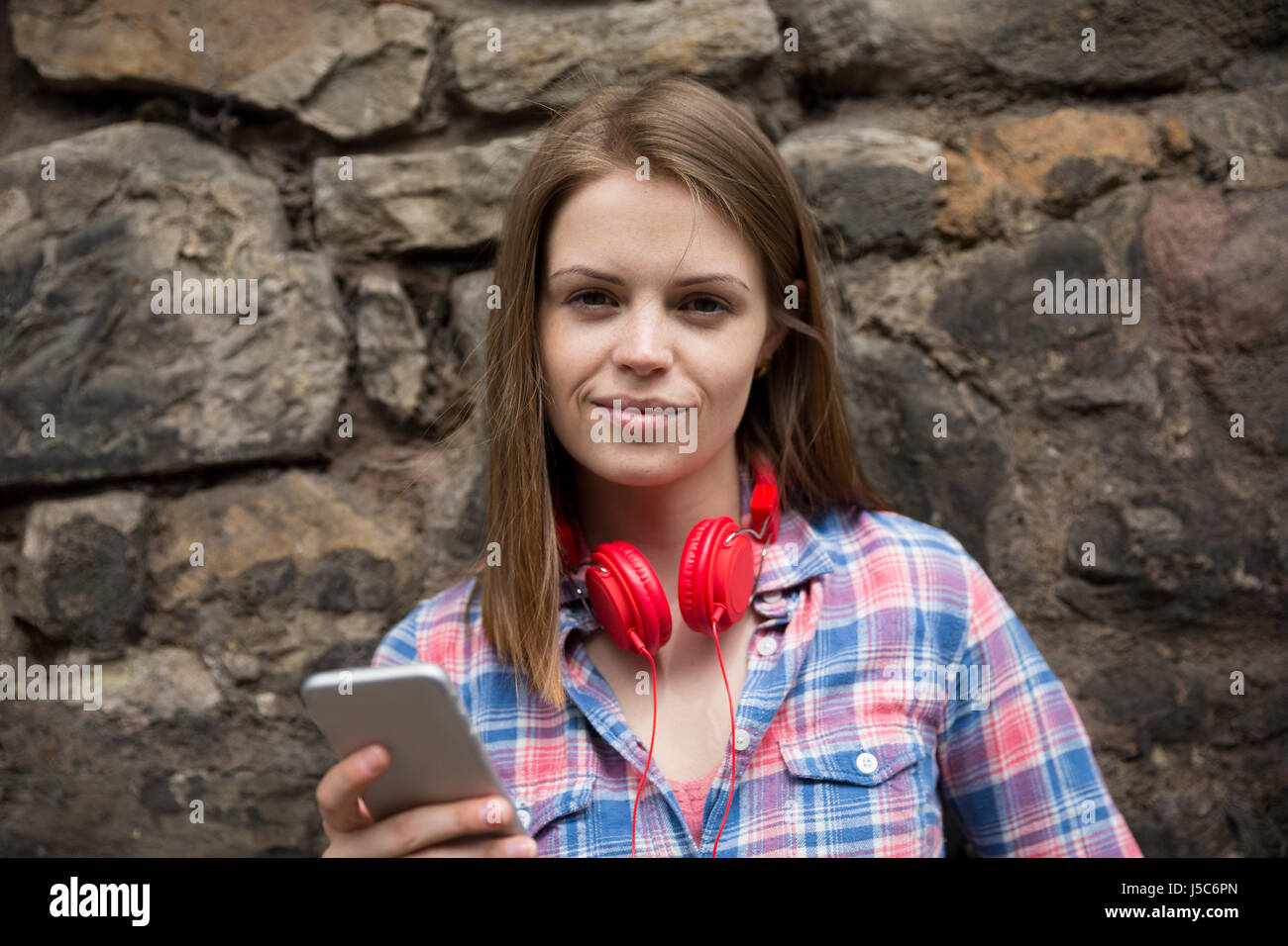 Portrait of a Young fashionable woman using a Smart Phone device. Stock Photo