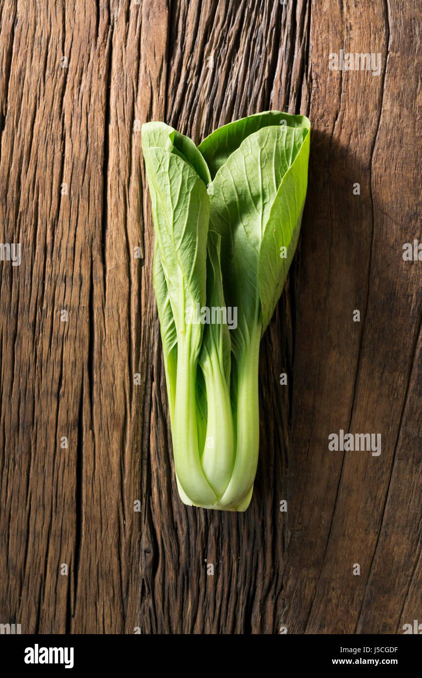 Bok choy or pak choi sitting on a rustic wooden background. Stock Photo
