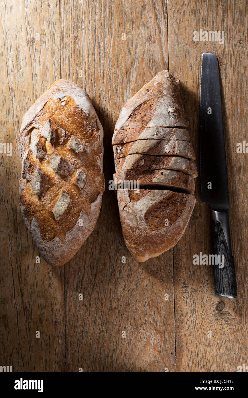 Above view of a rustic loaf of bread on an old wooden table Stock Photo ...