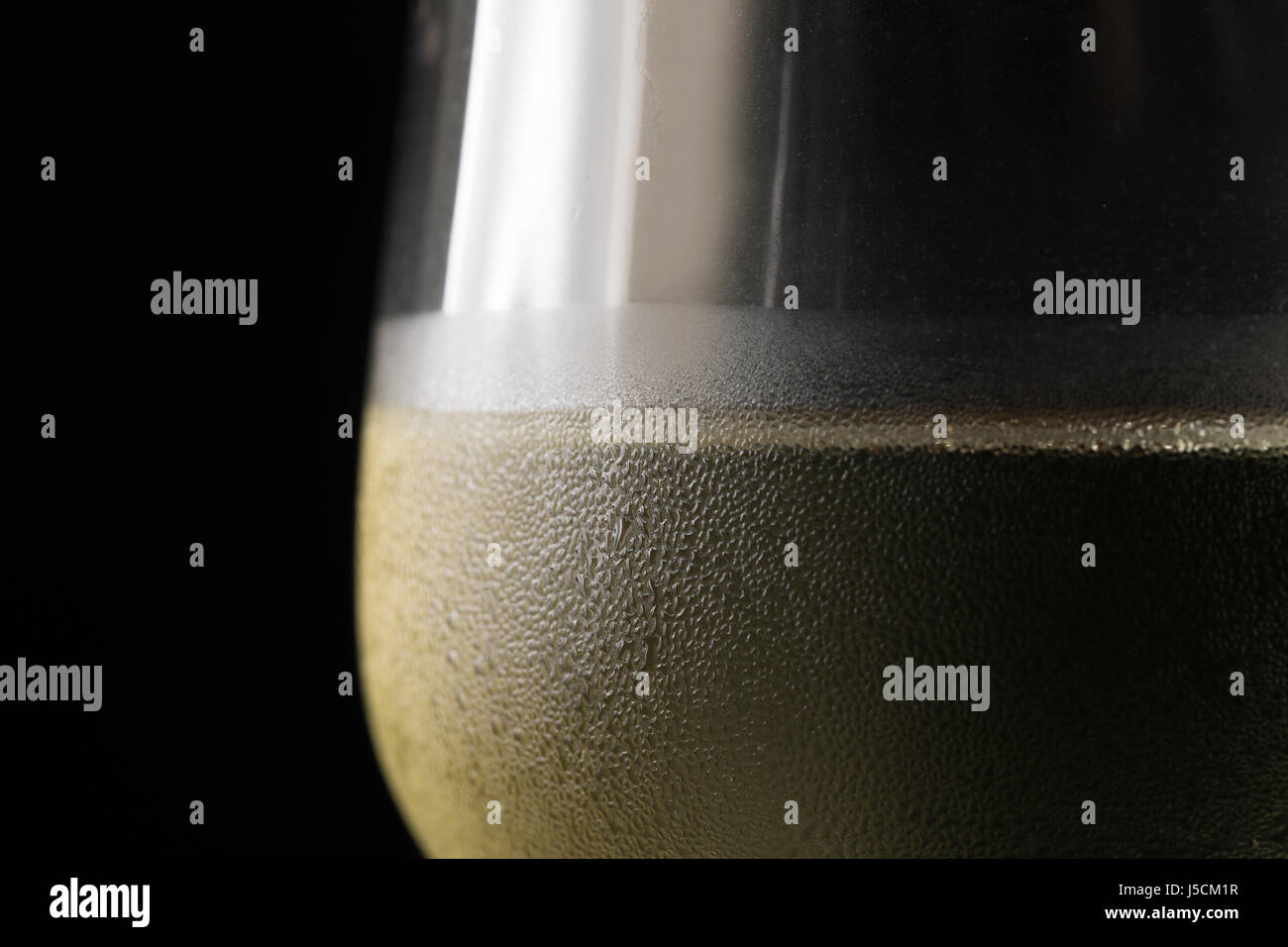 Close up detail of a cold glass of white wine. Stock Photo