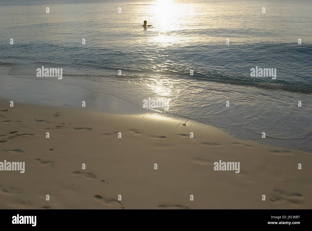 Footsteps in the soft sands of Tachogna Beach, Tinian Stock Photo