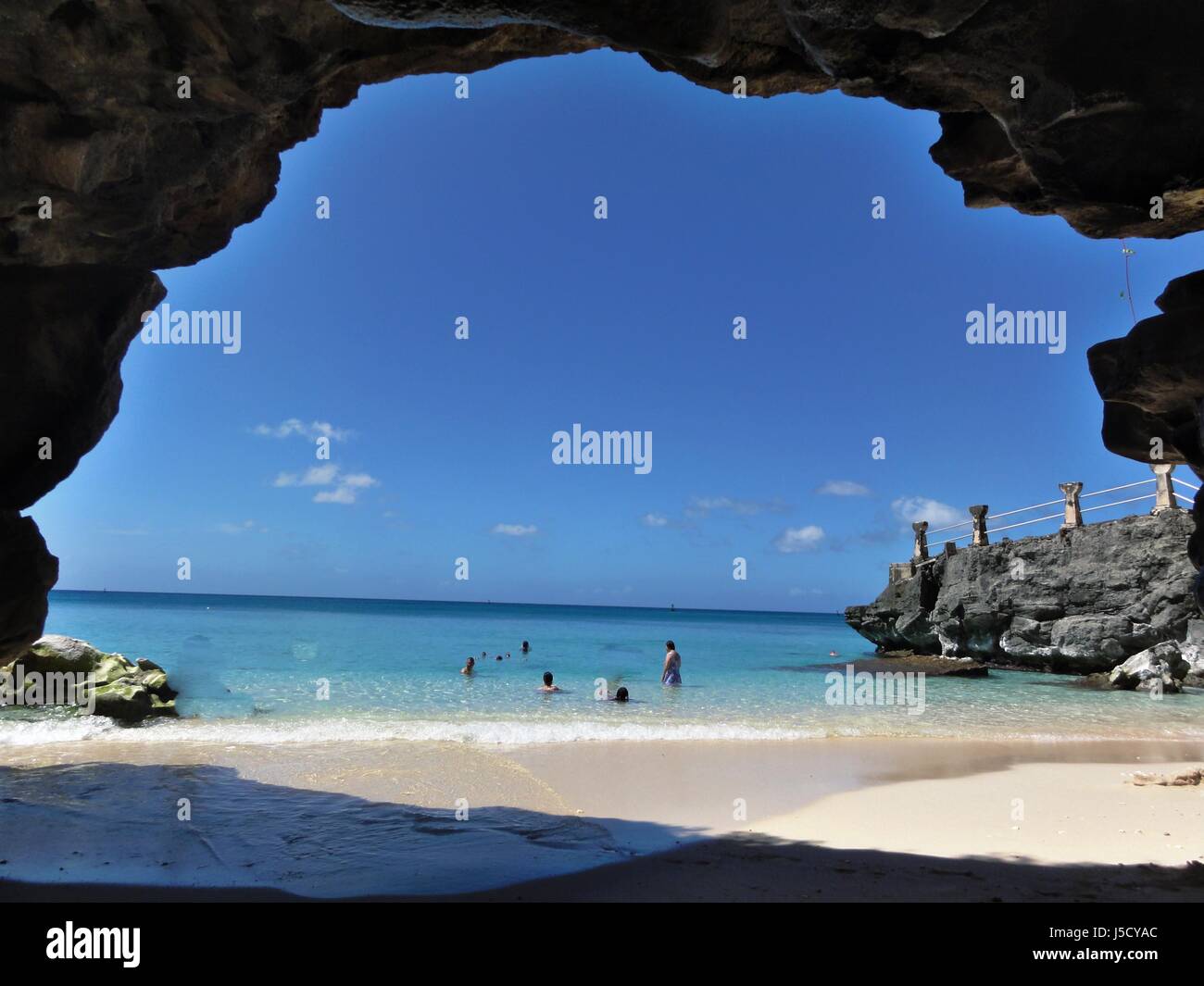 Taga Beach is an idyllic little cove below the cliff lines and is one of the top attractions in Tinian, Northern Mariana Islands. Stock Photo