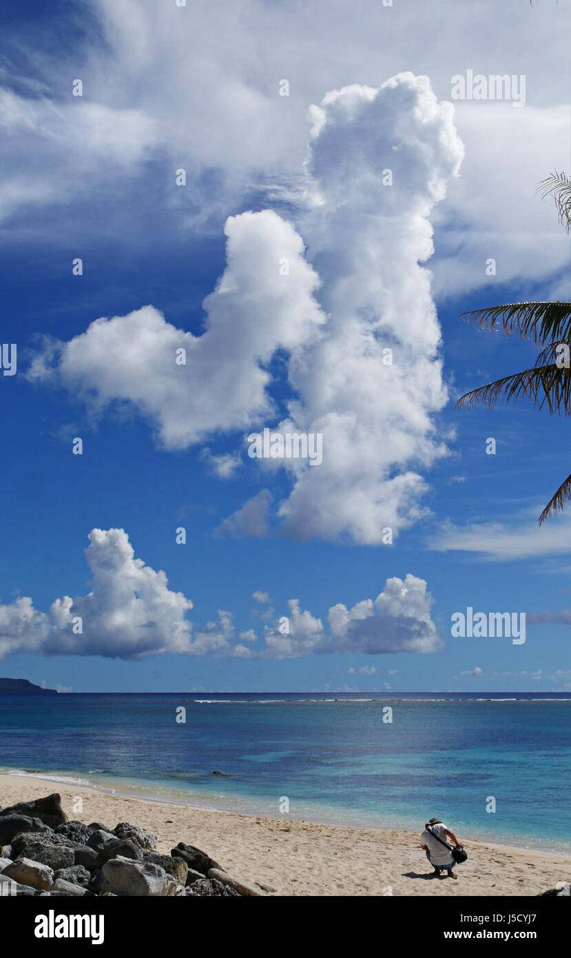 Gorgeous cloud formations above pristine blue waters of Tachogna Beach, Tinian Stock Photo